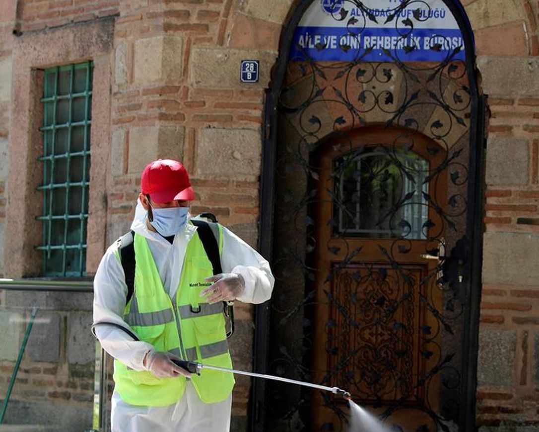 A Municipality worker disinfects the courtyard of historical Haci Bayram Mosque, in Ankara, Turkey, Thursday, May 28, 2020. Turkish authorities prepare mosques for communal prayers at limited capacity, observing social distancing rules, starting with Friday prayers since mosques shut down back in March; worshippers supposed to pray outside in mosque courtyards.