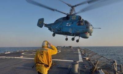 Boatswain’s Mate 3rd Class Jennifer Sahley salutes as a Ukrainian navy Ka-27 Helix helicopter takes off from the Arleigh Burke-class guided-missile destroyer USS Ross (DDG 71) during exercise Sea Breeze 2014 in the Black Sea.