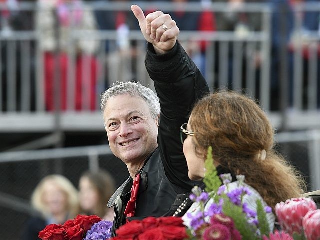 Grand Marshal Gary Sinise gives a thumbs up to the crowd at the 129th Rose Parade in Pasadena, Calif., Monday, Jan. 1, 2018. (AP Photo/Michael Owen Baker)