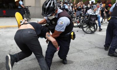 An officer takes down a protester after breaking through a police barrier during a march to bring attention to the death of George Floyd in the Loop Friday, May 29, 2020, in Chicago. Floyd died after being restrained by Minneapolis police officers on Memorial Day. (John J.