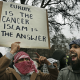 LONDON - FEBRUARY 03: Muslim demonstrators hold banners at the Danish Embassy on February 3, 2006 in London. British muslims have condemned newspaper cartoons which first appeared in a Danish newspaper, some of which depict the Prophet Mohammed wearing a turban shaped like a bomb. The cartoons have sparked worldwide …