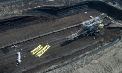 A photo from a "keep it in the ground" action at Vattenfall coalmine in Lusatia, Germany appears on the cover a new report on G20 governments financing fossil fuel projects.