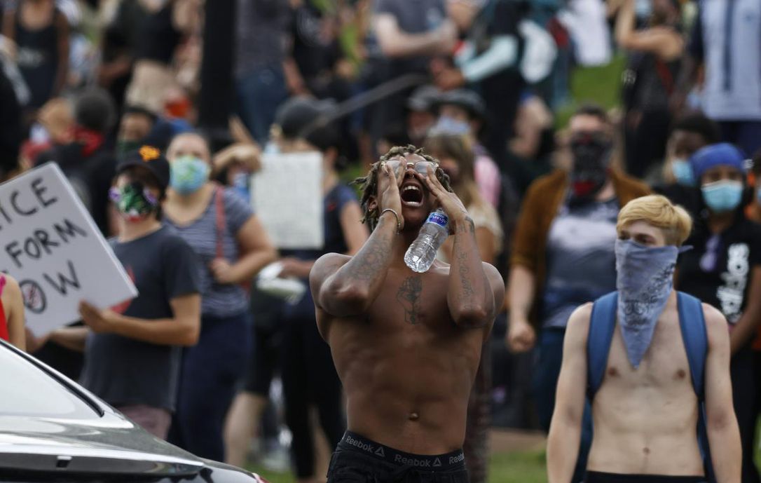 A young man yells during a protest outside the state capitol in Denver on Saturday over the death of George Floyd, a Black man who died while in police custody in Minneapolis.