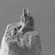 Black and white image of a 3D-printed castle on top of a pencil point.