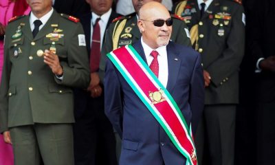 In this Aug. 12, 2015 file photo, Suriname President Desire "Desi" Delano Bouterse observes a military parade, after being sworn in for his second term, in Paramaribo, Suriname. The president stands a fair chance of holding onto power as the small South American nation elects a new National Assembly on Monday, May 25, 2020, a body that will choose the next president in August.