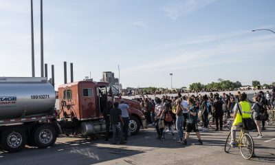 People react after a tanker truck drove into a crowd peacefully protesting the death of George Floyd on the I-35W bridge over the Mississippi River on May 31, 2020 in Minneapolis, Minnesota.