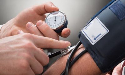 Close-up of a doctor checking a person's blood pressure.