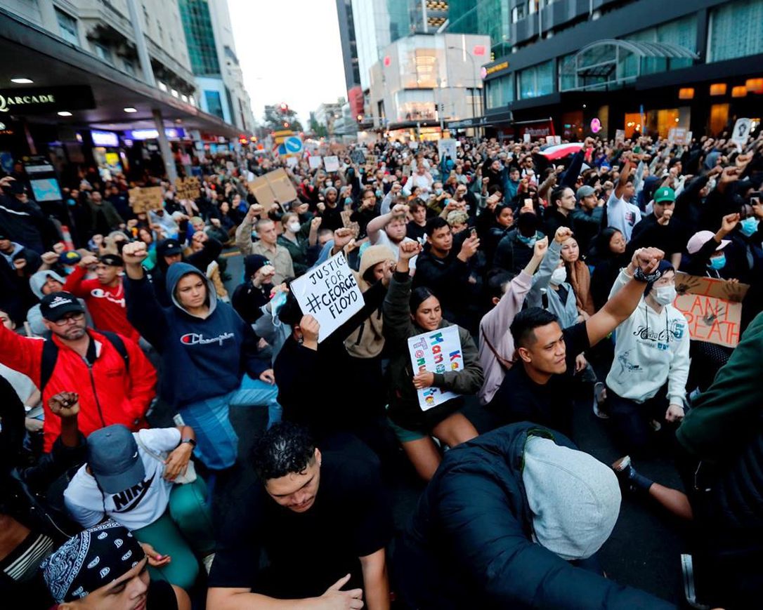 Demonstrators hold placards during a march in central Auckland, New Zealand, Monday, June 1. 2020, to protest the death of United States' George Floyd, a black man who died in police custody in Minneapolis on May 25. Floyd, who after a white police officer who is now charged with murder, Derek Chauvin, pressed his knee into Floyd's neck for several minutes even after he stopped moving and pleading for air.