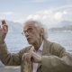 The artist Christo on the shore of Lake Iseo, where his work "The Floating Piers" would be installed, in the town of Sulzano, Italy, Sept. 19, 2015. He built a floating walkway, stretching nearly two miles, to connect two small islands. Christo, the Bulgarian-born conceptual artist who turned to epic-scale environmental works in the late 1960s, died on May 31 at his home in New York City. He was 84.