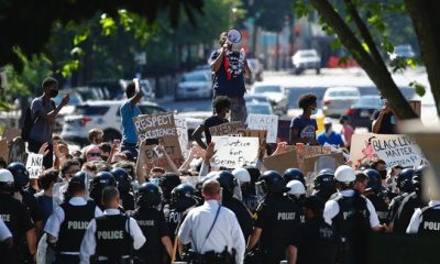 Protesters gather in front of a line of Uniformed U.S. Secret Service as demonstrators gather to protest the death of George Floyd, near the White House, Saturday, May 30, 2020, in Washington.
