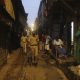 Police officials patrol in a lane during lockdown at the Dharavi slum, a COVID-19 hot spot in Mumbai, India, on Sunday.