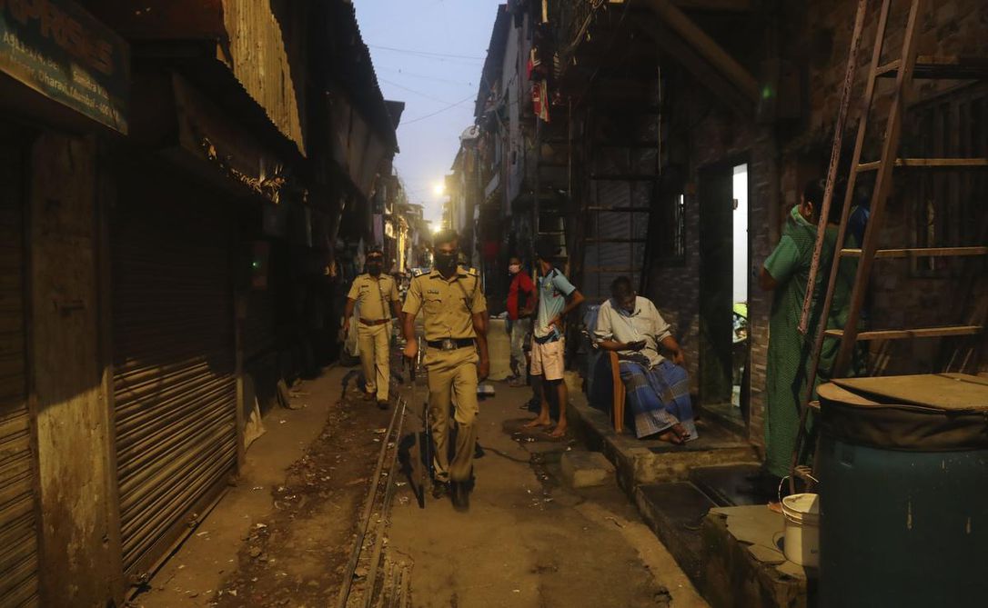 Police officials patrol in a lane during lockdown at the Dharavi slum, a COVID-19 hot spot in Mumbai, India, on Sunday.