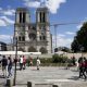 People walk on the forecourt of Notre Dame’s Cathedral, in Paris on Sunday. Notre Dame Cathedral’s forecourt is being opened up to the public for the first time since the devastating fire of April 15 last year.