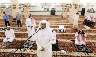 Saudi cleric Hammoud Al-Labban recites the call to prayers as worshippers wearing face masks and observing social distancing guidelines attend dawn prayers at al-Mirabi Mosque in Jiddah, Saudi Arabia, on Sunday.