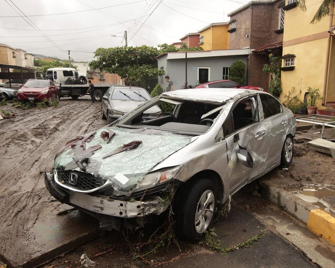 Vehicles stand damaged by the Acelhuate River after a flash flood at a neighborhood in San Salvador, El Salvador, Sunday, May 31, 2020. According to the Ministry of the Interior, at least seven people died across the country after two days of heavy rains.