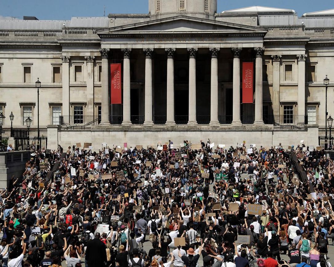 People, some of them kneeling gather in Trafalgar Square in central London on Sunday, May 31, 2020 to protest against the recent killing of George Floyd by police officers in Minneapolis that has led to protests across the US.
