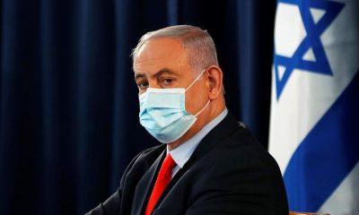 Israeli Prime Minister Benjamin Netanyahu wears a mask as he looks on during the weekly cabinet meeting in Jerusalem Saturday, May 31, 2020.