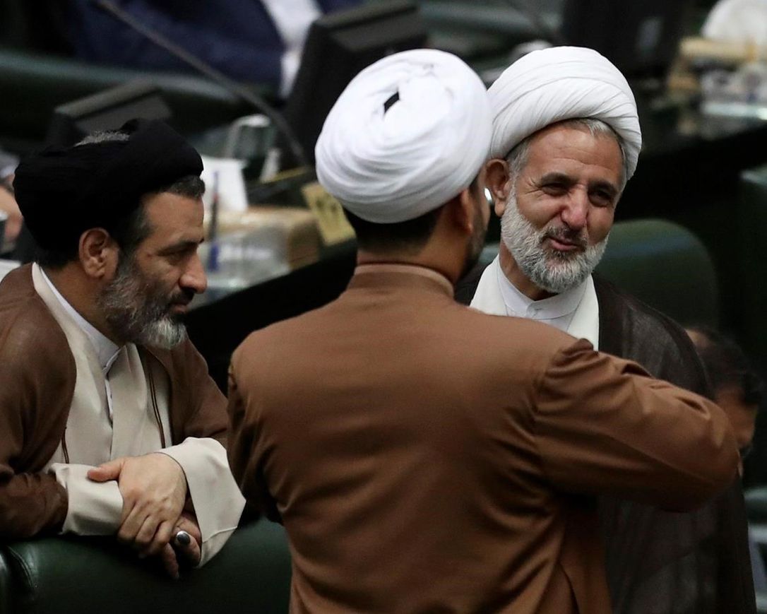 In this Wednesday, May, 27, 2020 photo, Iranian lawmaker Mojtaba Zolnouri, right, who is the head of the influential parliamentary committee for national security and foreign policy, speaks with his colleagues during the inauguration of the new parliament in Tehran, Iran. Zolnouri said Monday, June 1, 2020, that 230 people were killed November's anti-government protests in Iran, which were among the worst the country has seen since its 1979 Islamic Revolution.