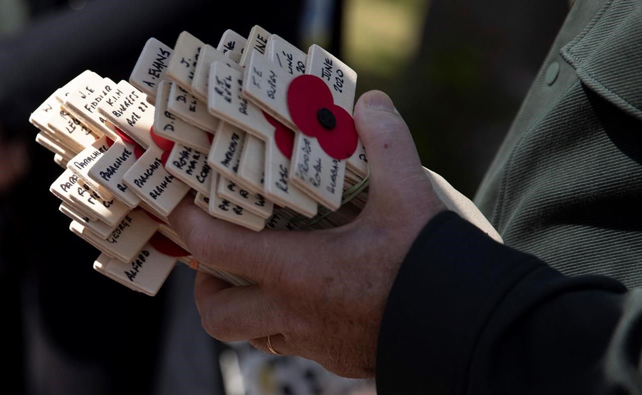 Wooden crosses with names of the Second World War dead are held prior to being laid for the Portsmouth Trust group by British expatriate Steven Oldrid during D-Day ceremonies at the local war cemetery in Bénouville, Normandy, France, on Saturday.