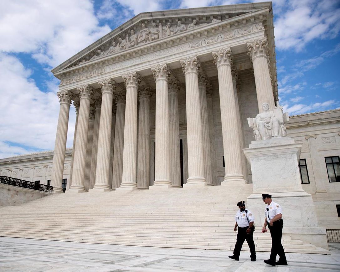 In this May 14, 2020, file photo security officers walk in front of the Supreme Court in Washington.
