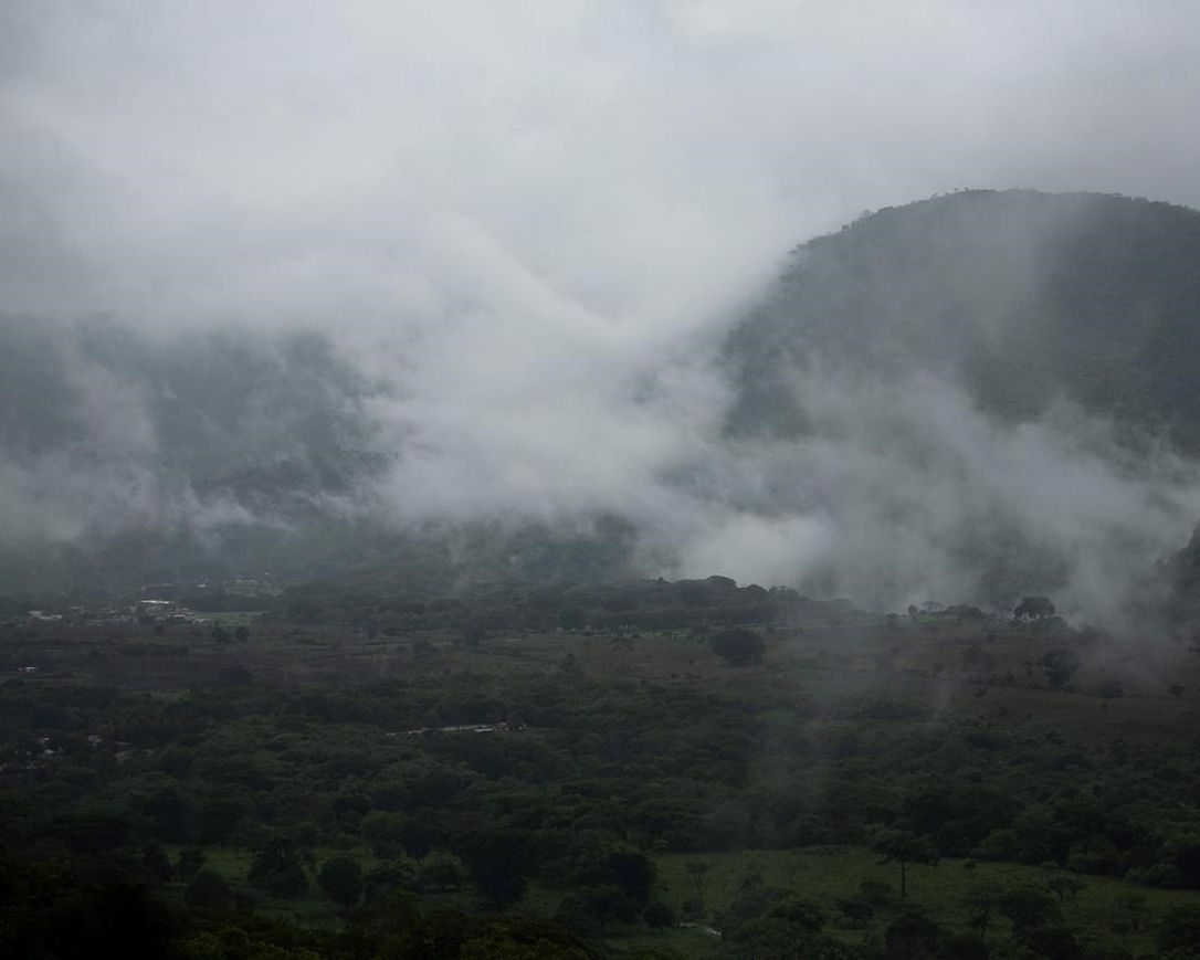 Rain clouds hover over mountains during tropical storm Amanda in Barberena, eastern Guatemala, Sunday, May 31, 2020. The first tropical storm of the Eastern Pacific season drenched parts of Central America on Sunday and officials in El Salvador said at least seven people had died in flooding.