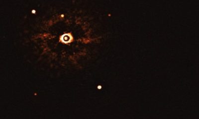 Image of the parent star and its two exoplanets in the bottom-right hand corner of the image.