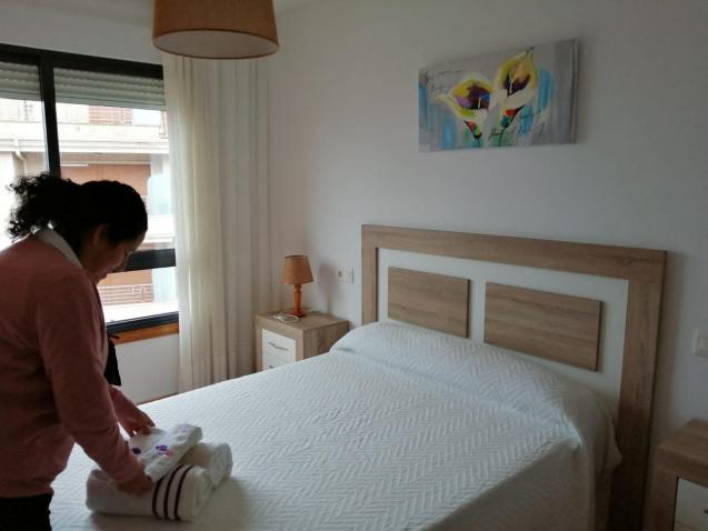 Airbnb host Perla Requejo folds towels in the property that she rents to holidaymakers on Airbnb in Sanxenxo