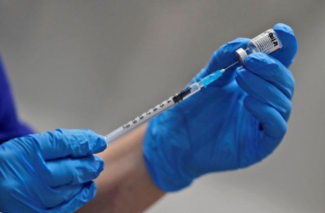 A nurse prepares to administer the Pfizer-BioNTech COVID-19 vaccine